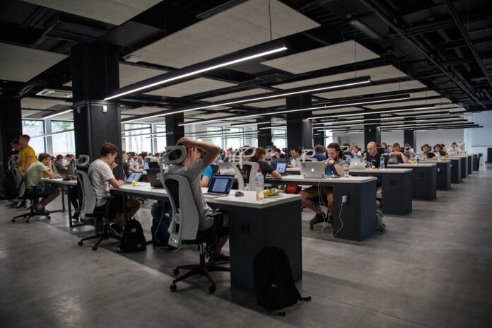 Employees in a busy open office using enterprise search systems